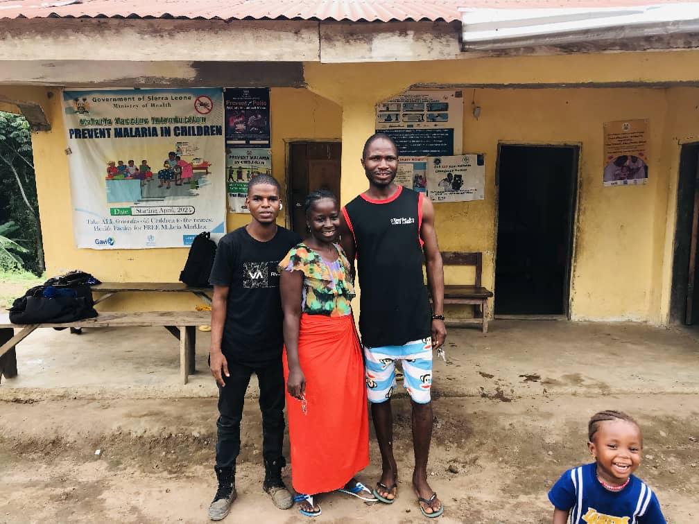 Community members outside a health post in Sierra Leone.